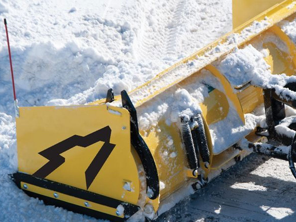 SnowWolf Ultra snow plows with trip edge for skid steer loaders